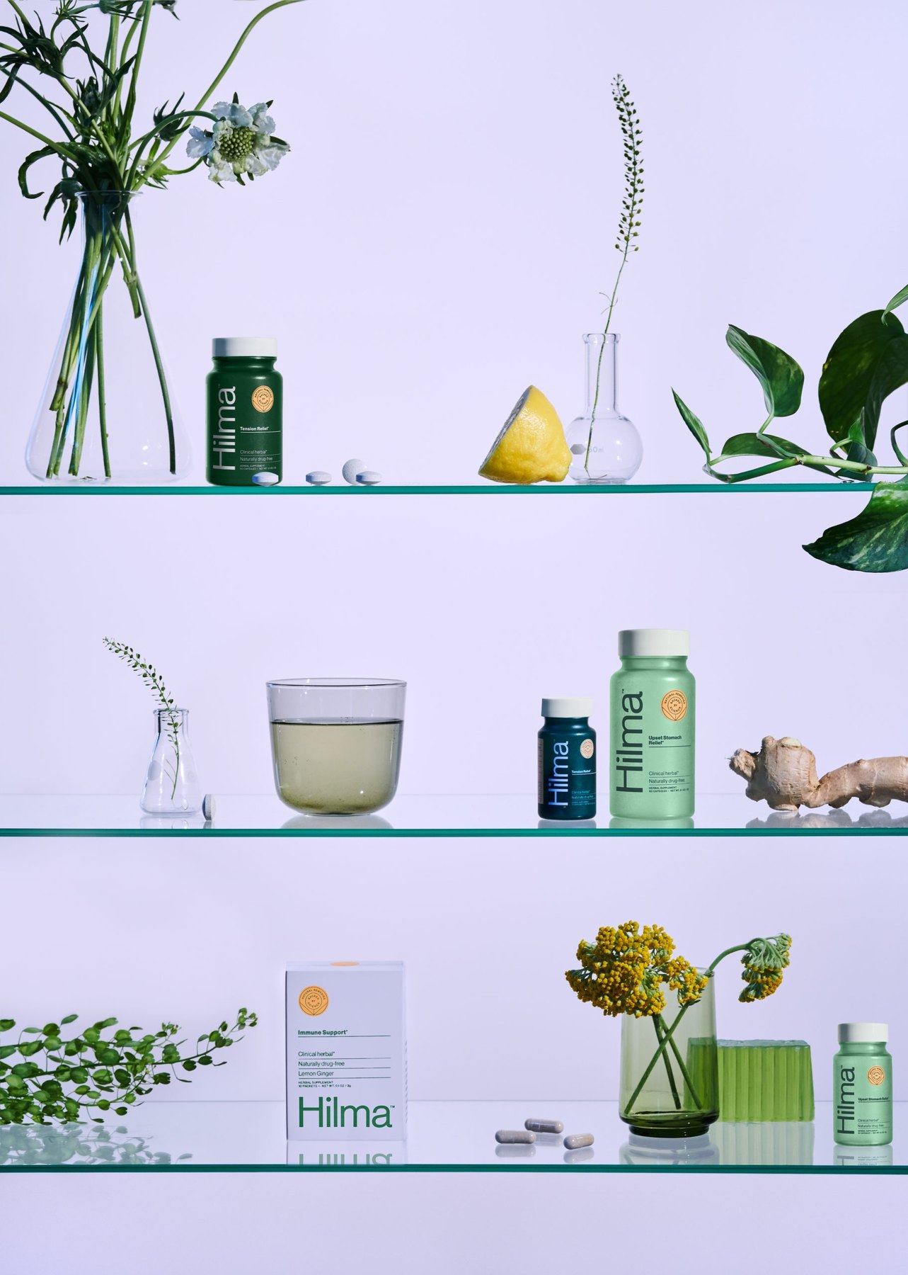 Shelved Hilma products styled with plants citrus and tea.