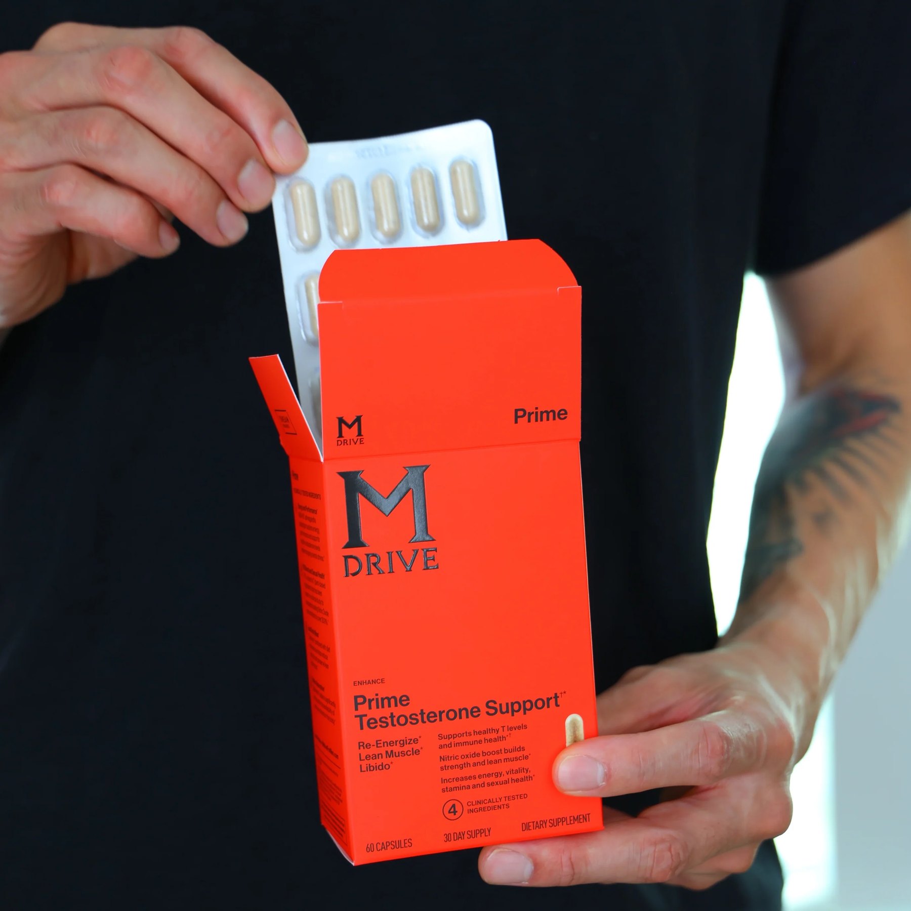 Close view of Prime packaging with capsules being removed.