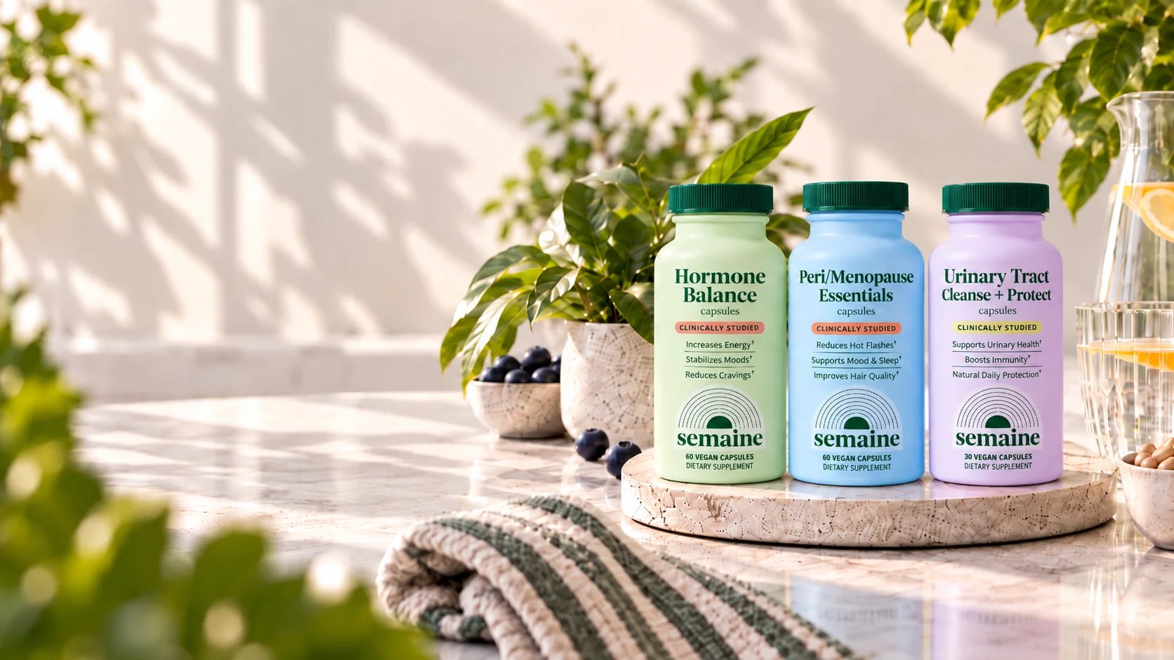 Lifestyle still of Semaine bottles with plants and linen.