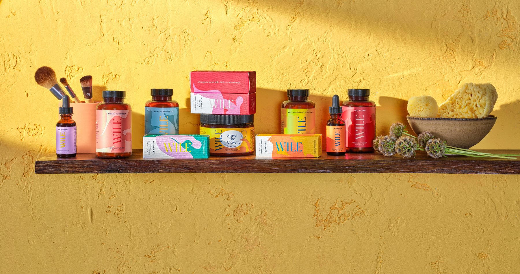 Multiple Wile supplements styled on wood against textured background.